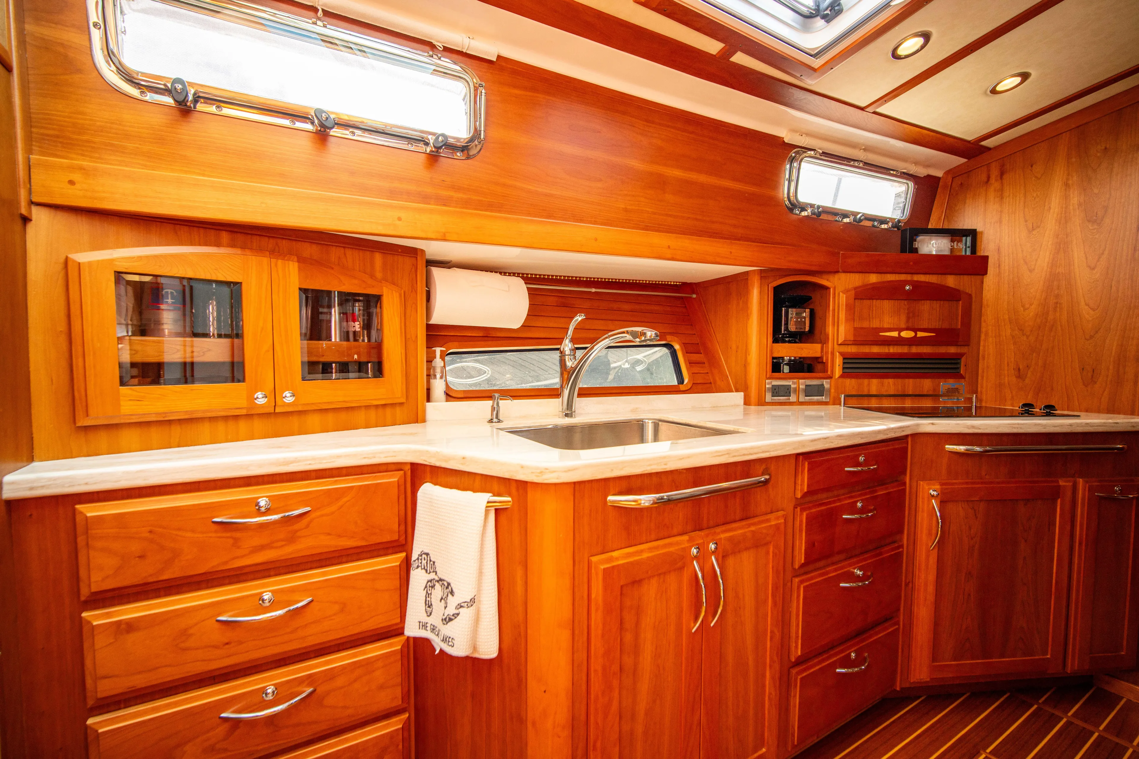  Yacht Photos Pics Luxurious 2015 Sabre 48 Salon Express yacht interior with elegant wooden cabinetry and modern fixtures.