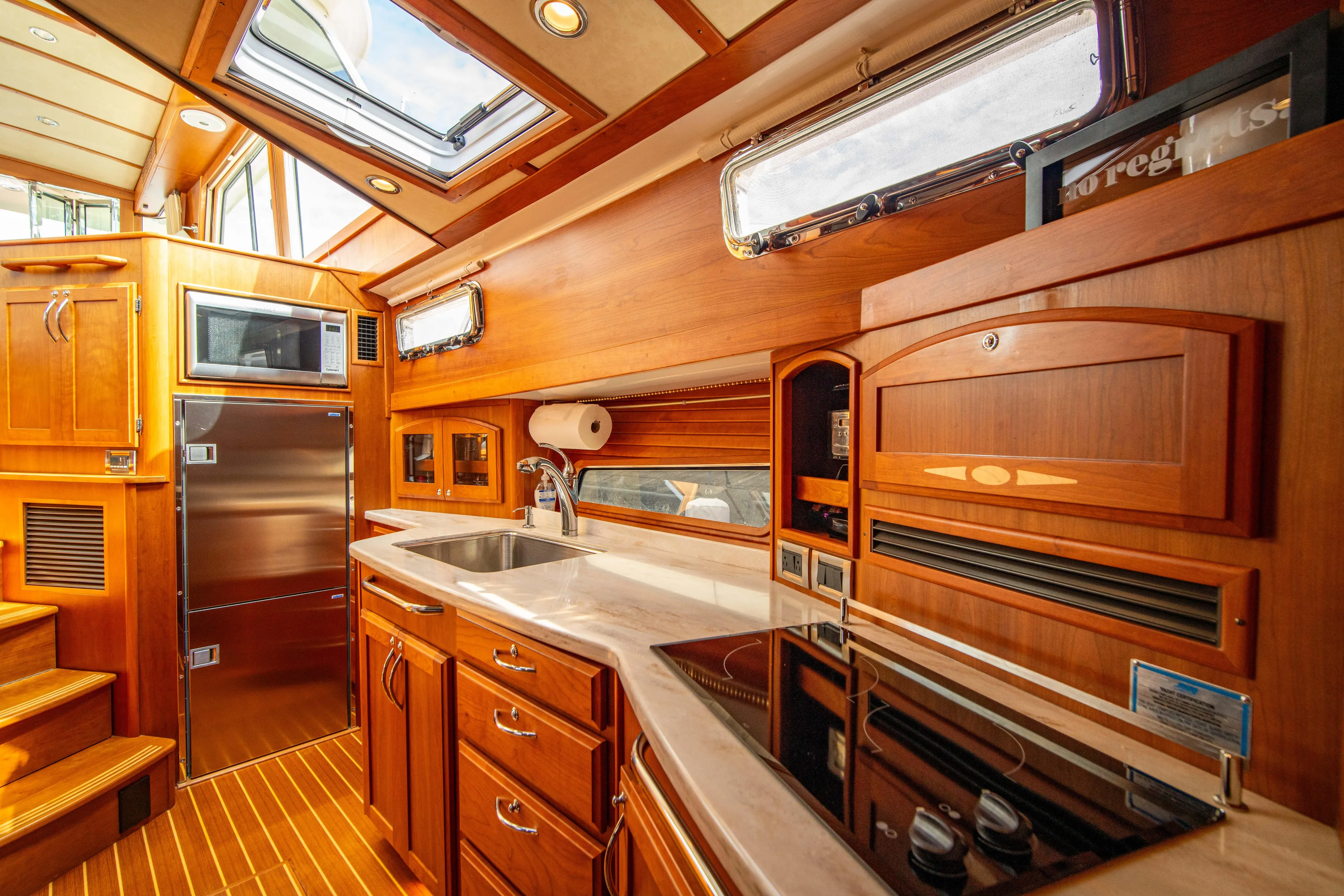  Yacht Photos Pics Luxurious 2015 Sabre 48 Salon Express yacht kitchen with wood cabinetry and modern appliances.