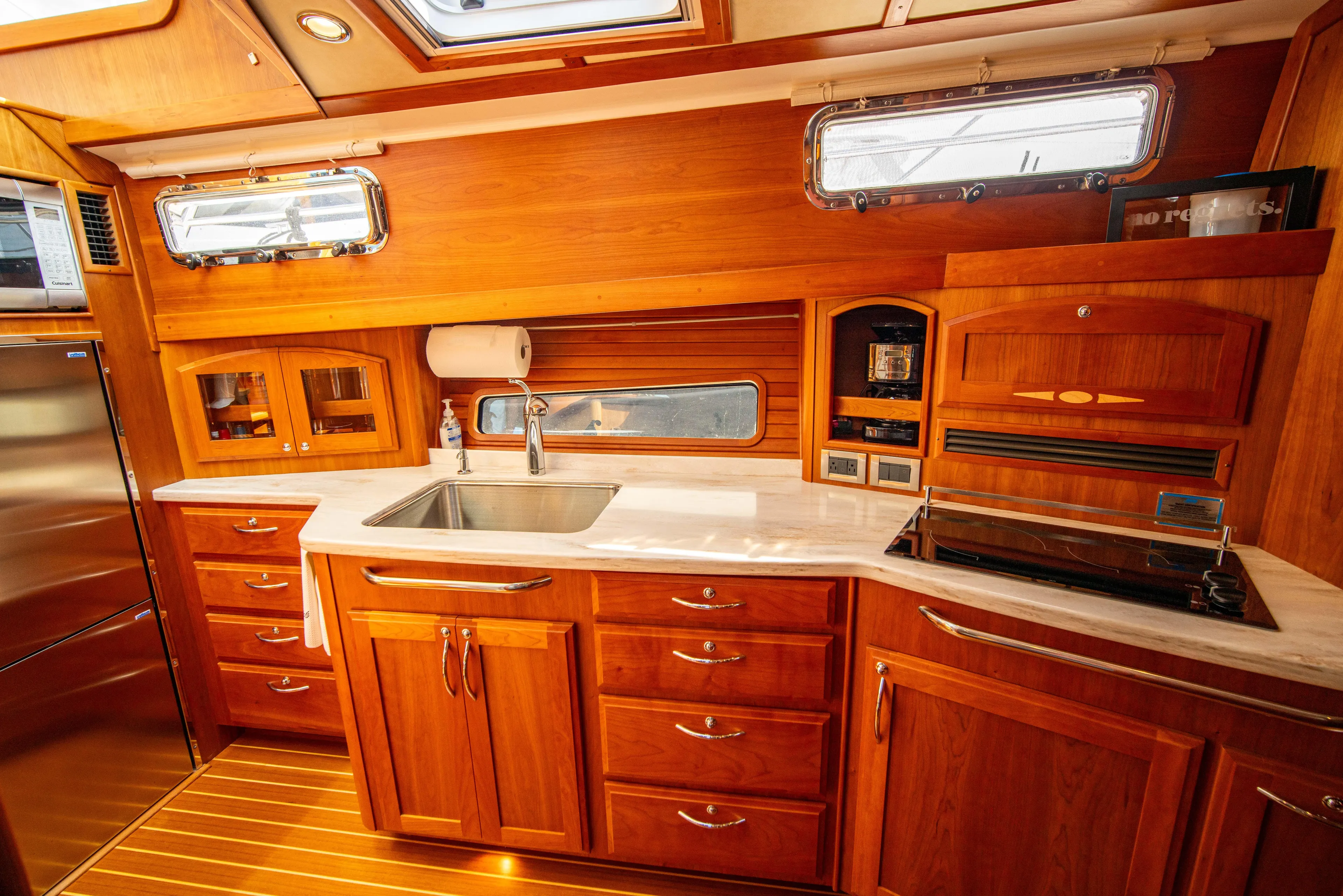  Yacht Photos Pics Luxurious 2015 Sabre 48 Salon Express yacht kitchen with wooden cabinetry and modern appliances.