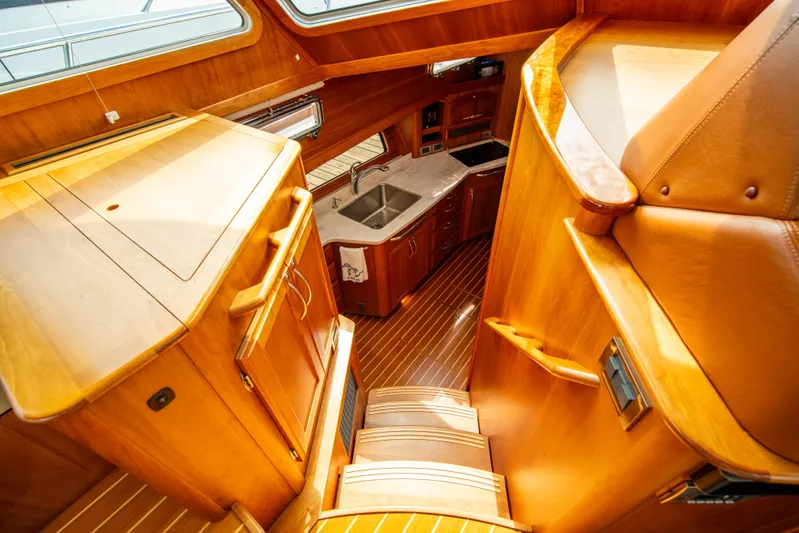  Yacht Photos Pics Interior of 2015 Sabre 48 Salon Express yacht with wooden cabinetry and stairs.
