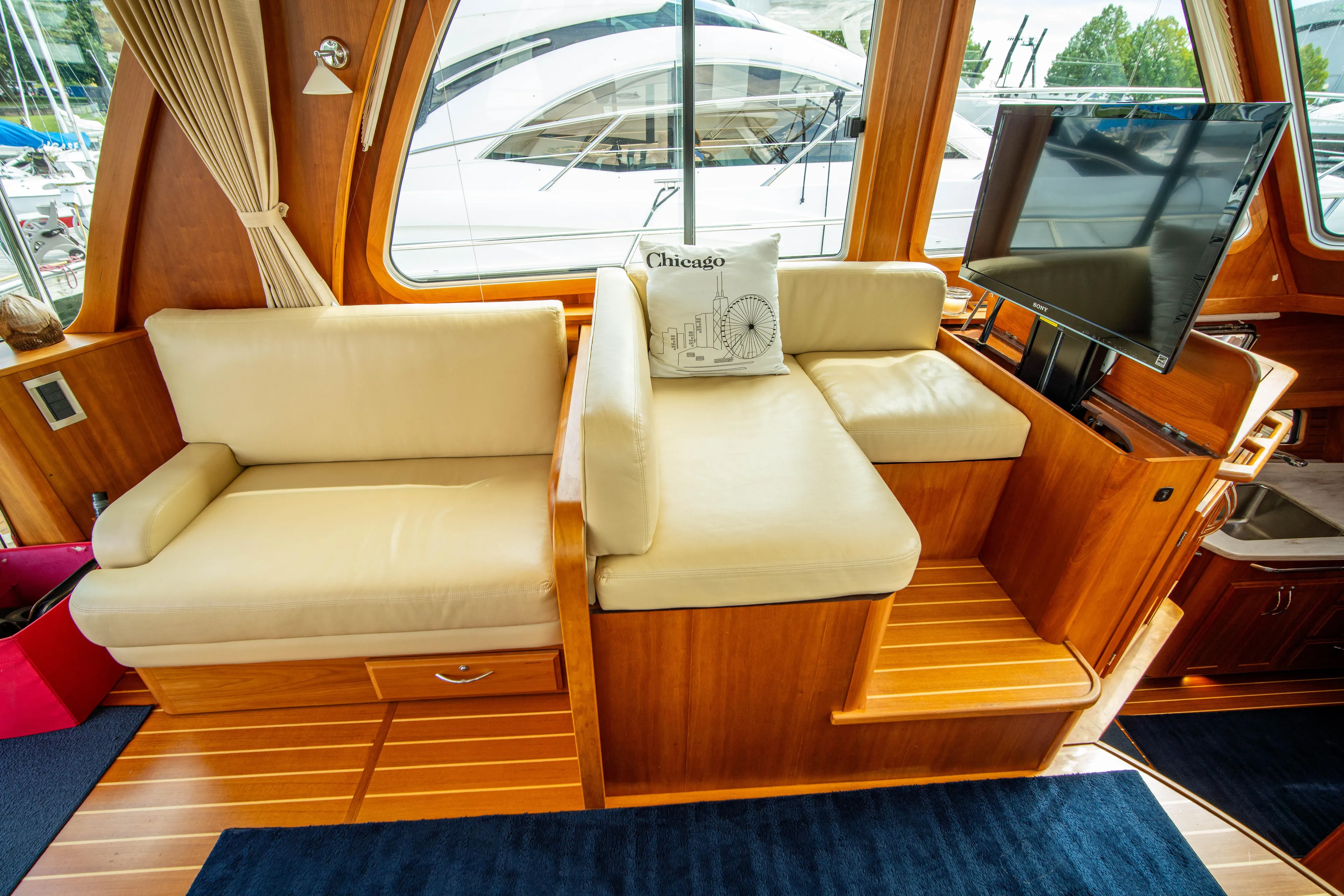  Yacht Photos Pics Interior of 2015 Sabre 48 Salon Express with beige seating and TV.