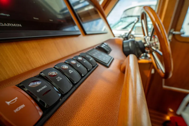  Yacht Photos Pics Control panel of 2015 Sabre 48 Salon Express yacht with wooden steering wheel.