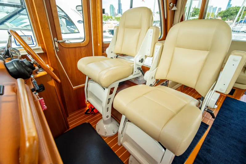  Yacht Photos Pics 2015 Sabre 48 Salon Express interior with beige captain chairs and wooden accents.