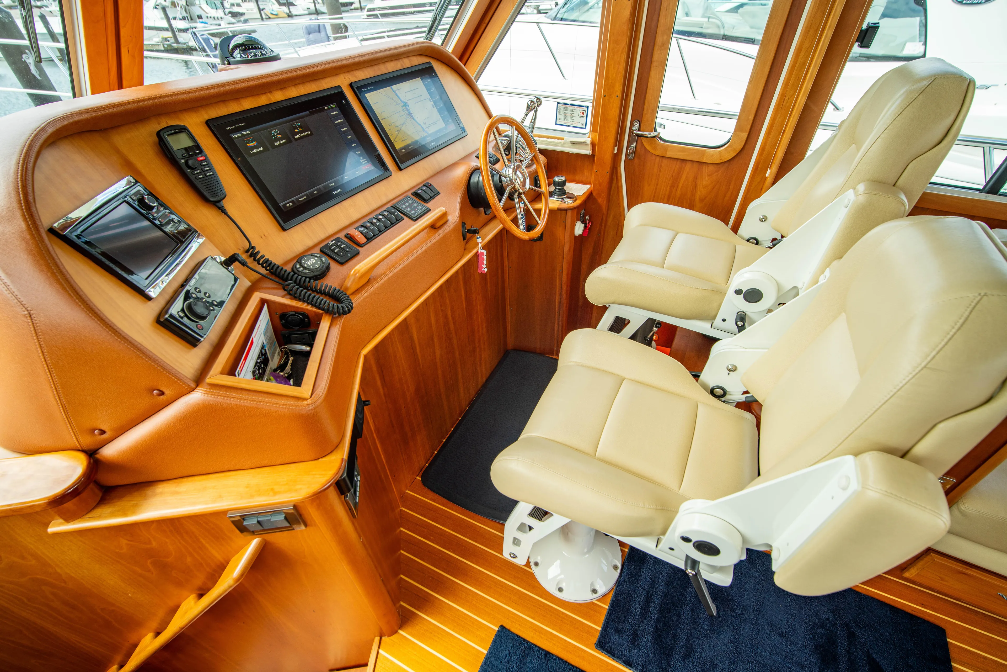  Yacht Photos Pics Interior of 2015 Sabre 48 Salon Express yacht with leather seats and navigation controls.