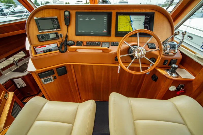  Yacht Photos Pics Interior helm of 2015 Sabre 48 Salon Express with navigation screens and steering wheel.