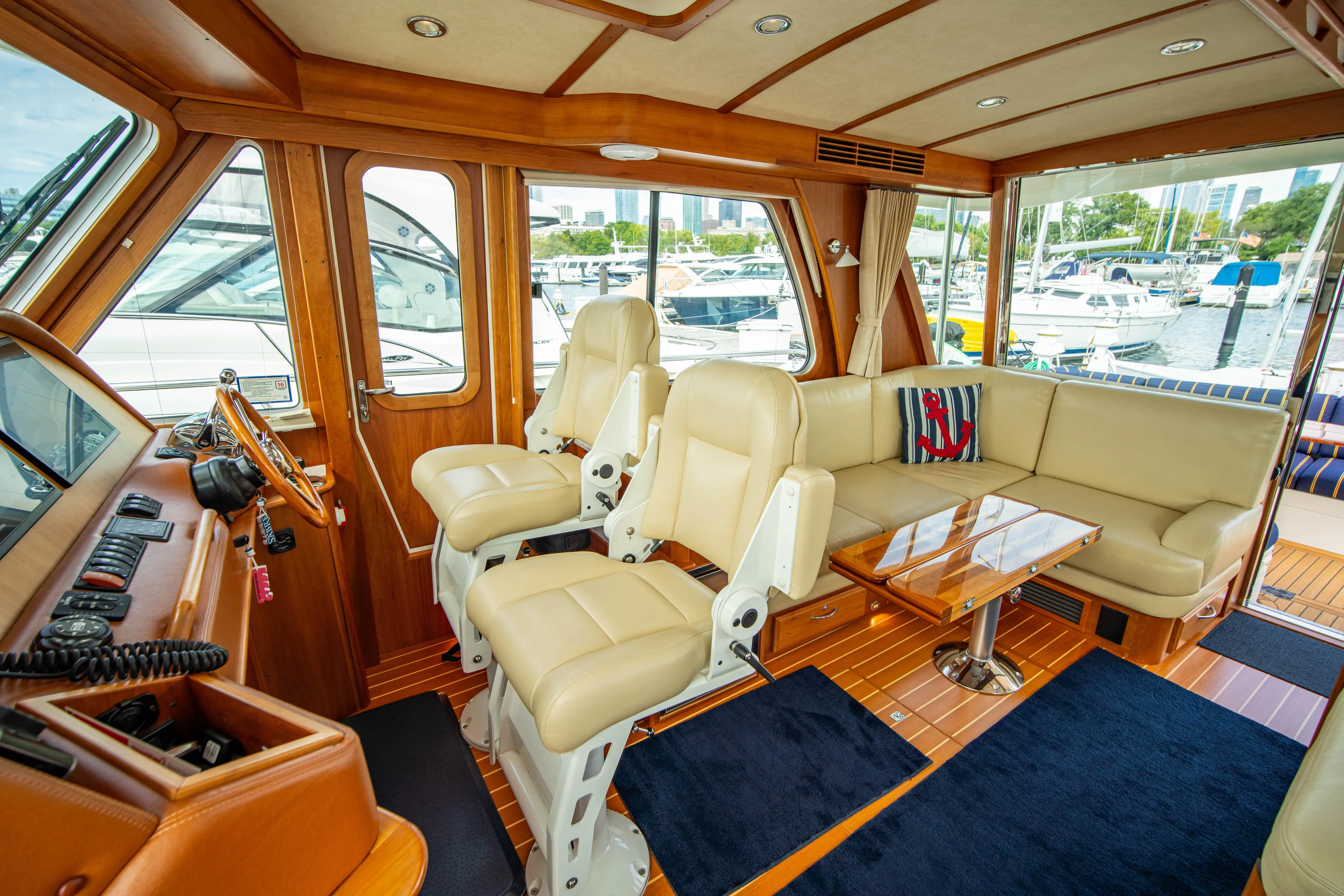  Yacht Photos Pics Interior of 2015 Sabre 48 Salon Express yacht with luxurious seating and helm.