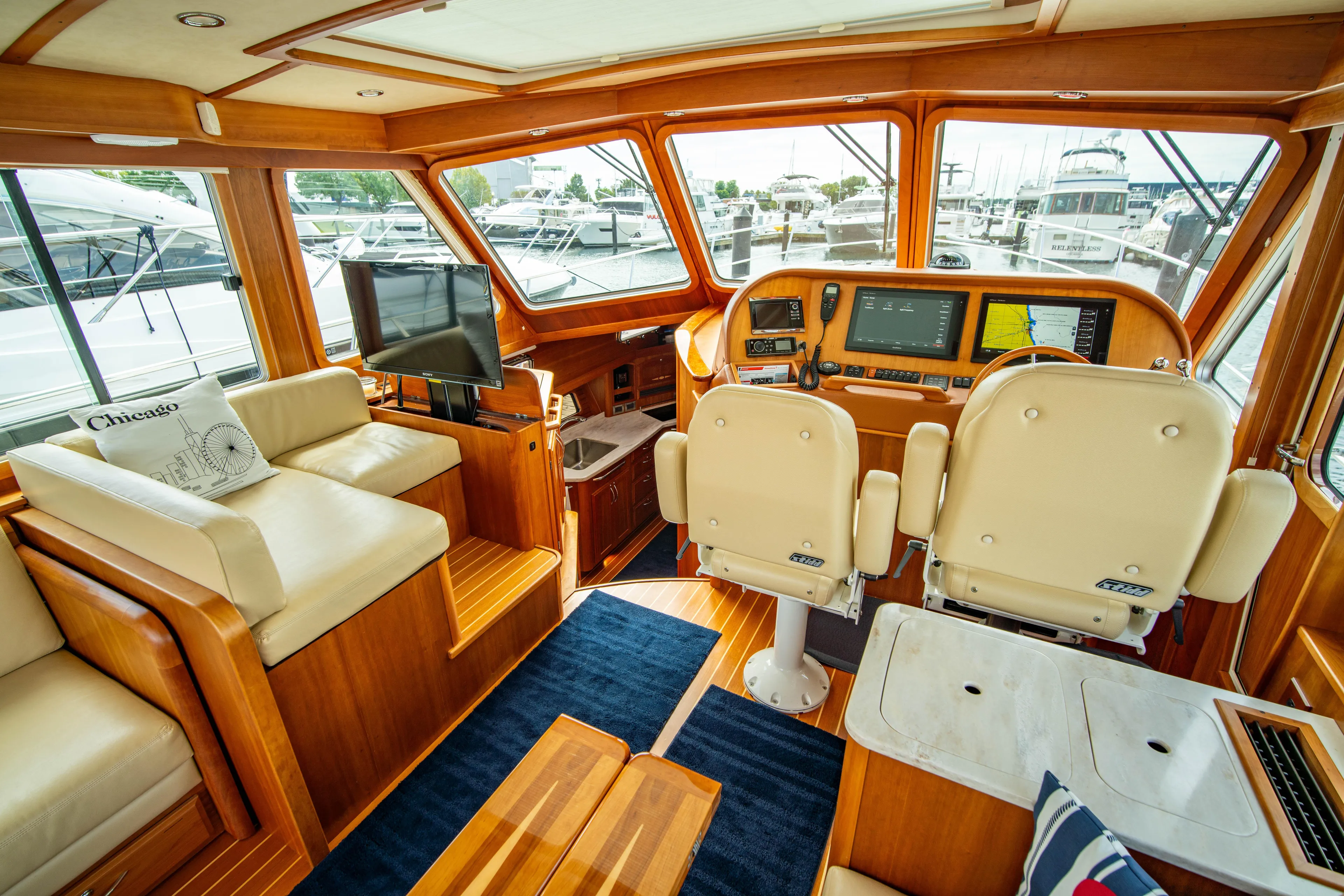 Yacht Photos Pics Interior of 2015 Sabre 48 Salon Express yacht with luxurious seating and navigation equipment.