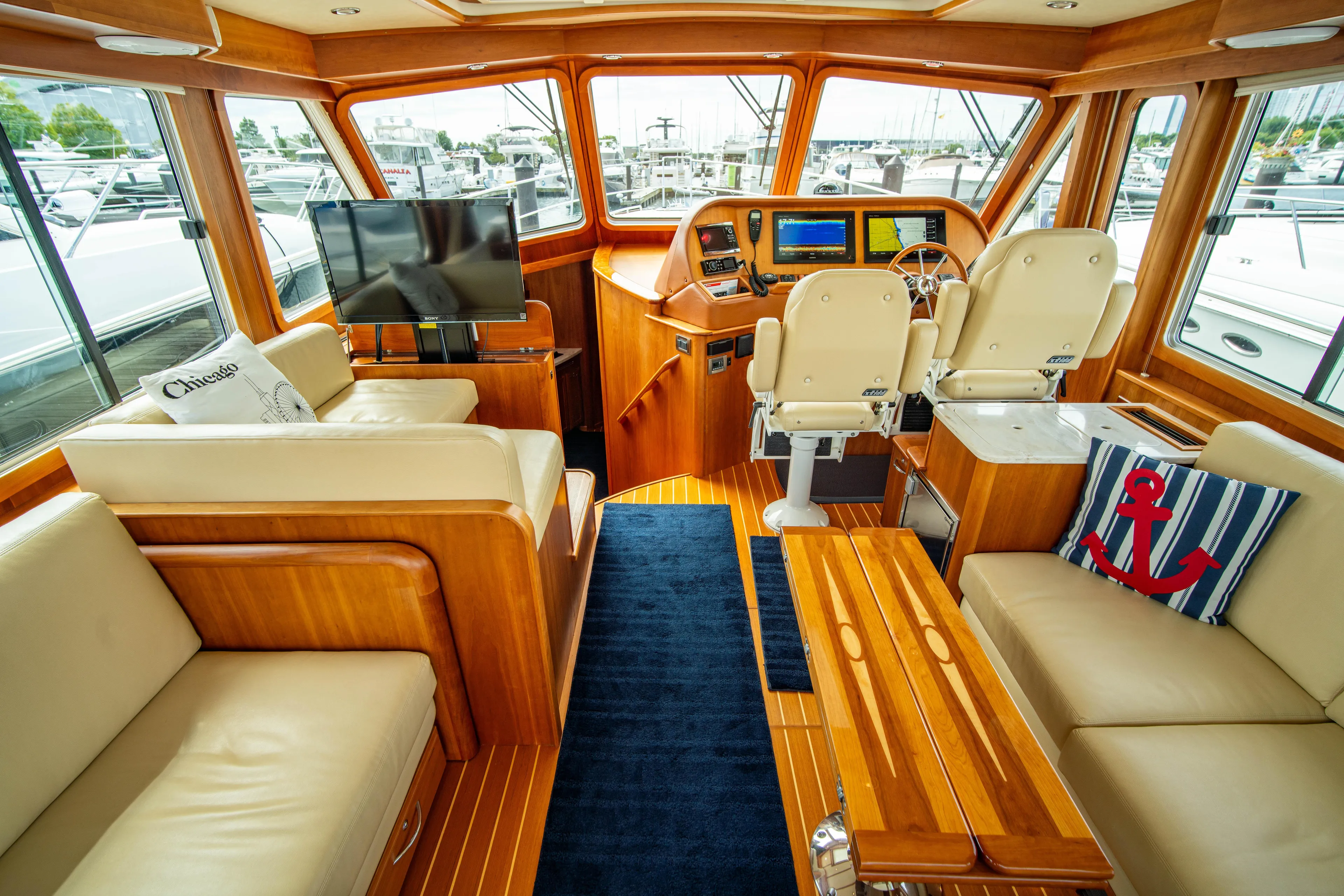  Yacht Photos Pics Luxurious interior of 2015 Sabre 48 Salon Express yacht with leather seating and modern helm.