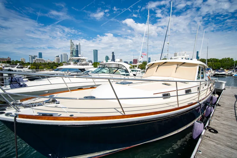  Yacht Photos Pics 2015 Sabre 48 Salon Express yacht docked in marina, city skyline in background.