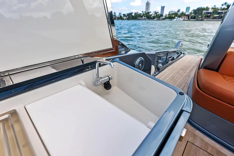 Il-viaggio Yacht Photos Pics Luxury yacht Riva 56 RIVALE 2021 with onboard sink and scenic waterfront view.
