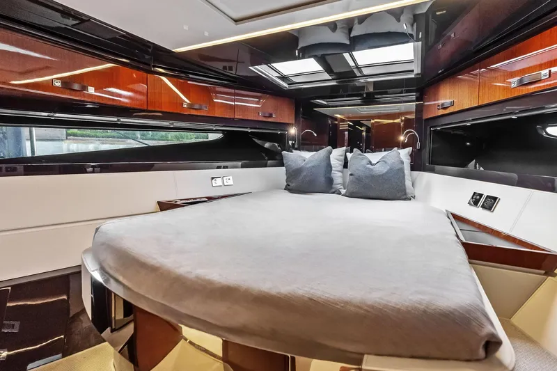 Il-viaggio Yacht Photos Pics Luxurious interior of 2021 Riva 56 Rivale yacht with elegant bedding and wood finishes.