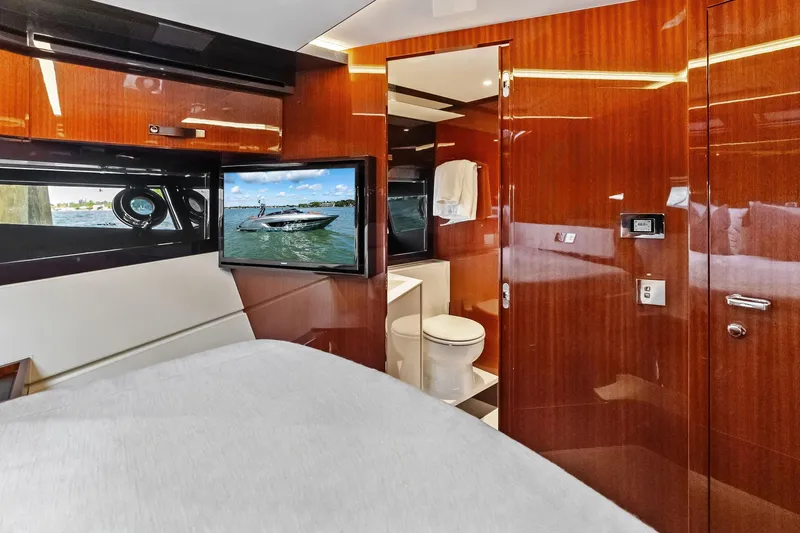 Il-viaggio Yacht Photos Pics Luxurious interior of 2021 Riva 56 Rivale yacht with wood paneling and modern amenities.