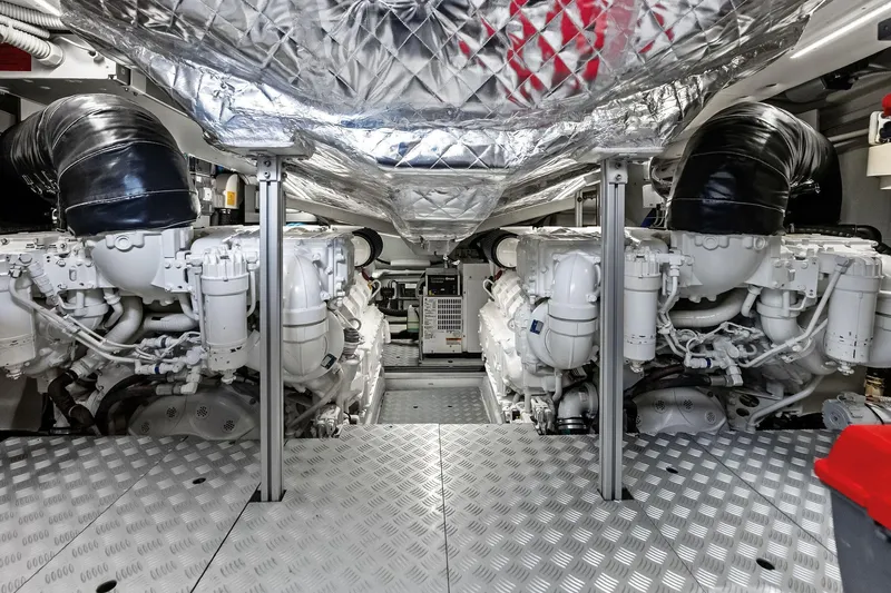 Il-viaggio Yacht Photos Pics Engine room of 2021 Riva 56 RIVALE yacht, showcasing dual engines and metallic flooring.