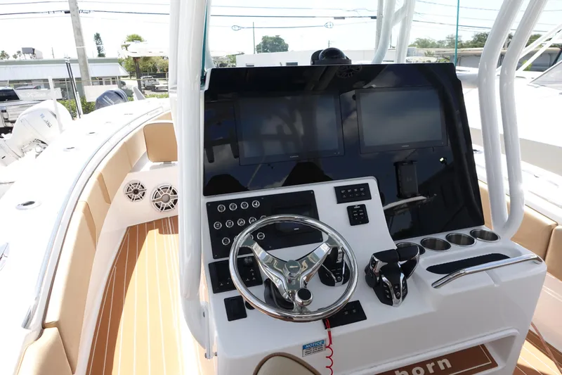  Yacht Photos Pics 2022 Cape Horn 34 XS boat dashboard with steering wheel and electronic controls.