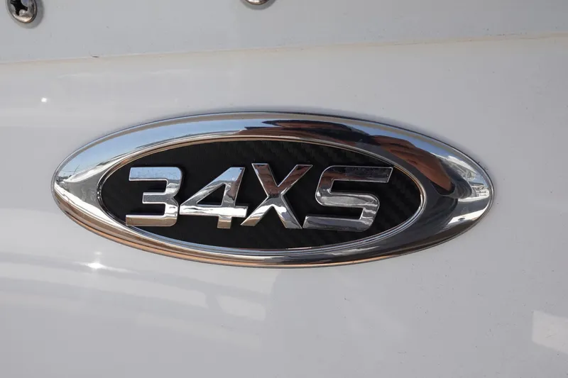  Yacht Photos Pics Chrome emblem of 2022 Cape Horn 34 XS boat model on white surface.