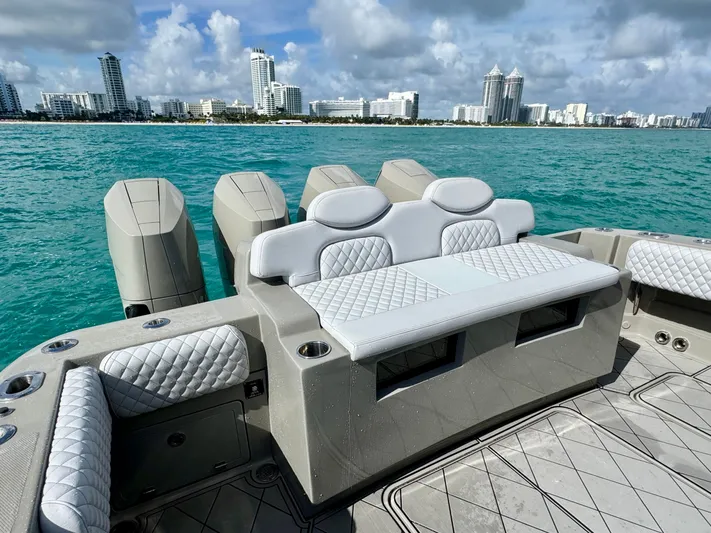 Reel Cool Yacht Photos Pics Luxurious HCB Lujo 2024 boat with elegant seating and coastal backdrop.