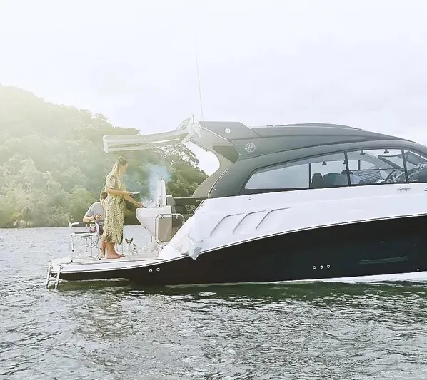  Yacht Photos Pics 2025 Hanover 355 yacht with people enjoying a barbecue on the water.