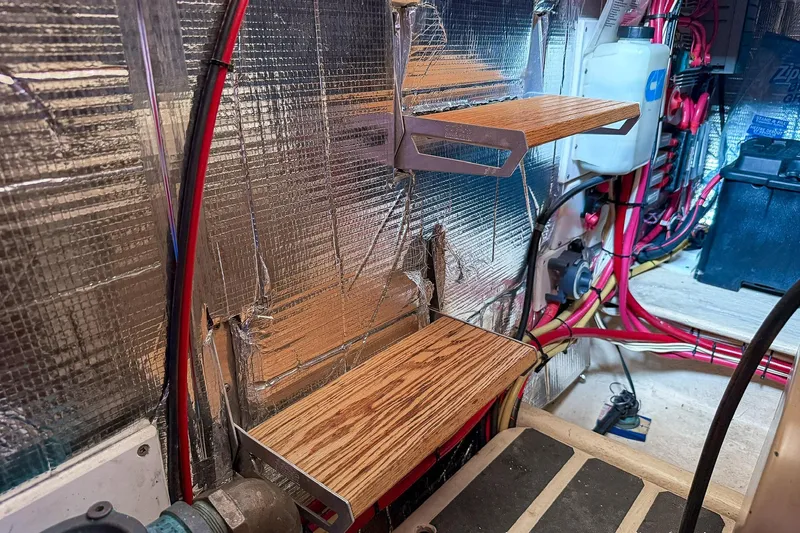 Dee Gee Yacht Photos Pics Engine room of a 1999 Nordic Tug 37 with shelves and wiring.