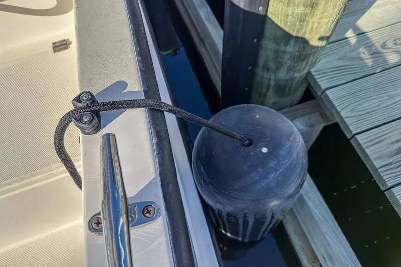 Dee Gee Yacht Photos Pics Nordic Tug 37 (1999) docked with fender and cleat securing the boat.