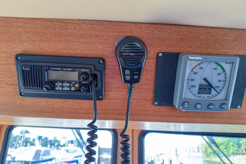 Dee Gee Yacht Photos Pics VHF marine radio and wind gauge on 1999 Nordic Tug 37 boat dashboard.