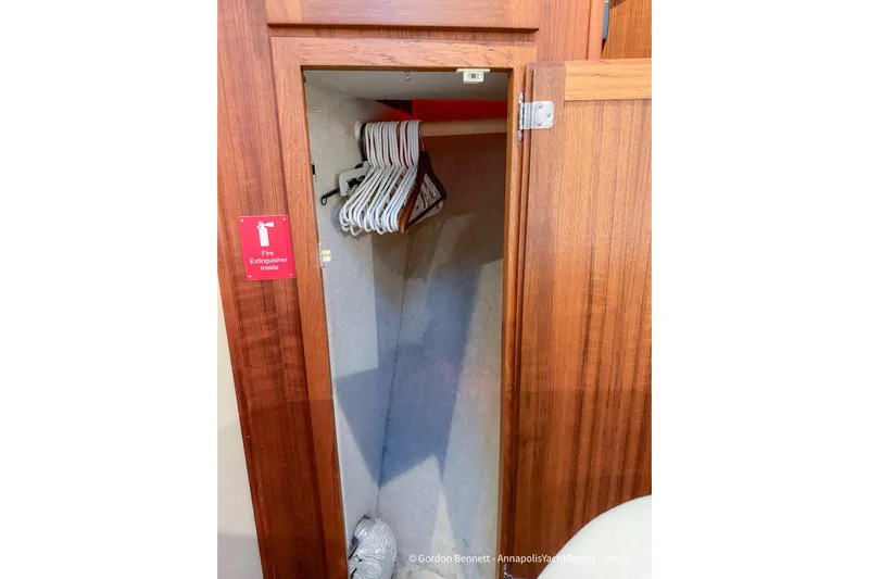 Dee Gee Yacht Photos Pics Wooden closet with hangers and fire extinguisher inside Nordic Tug 37, 1999 model.