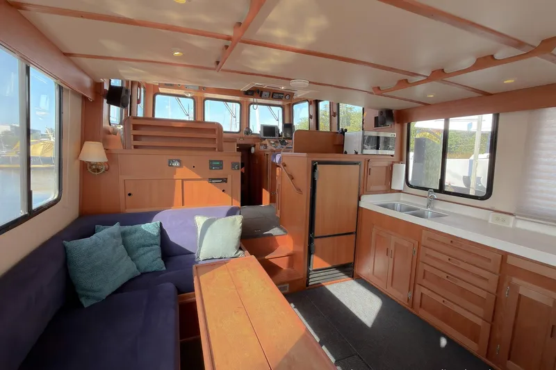 Dee Gee Yacht Photos Pics Interior of 1999 Nordic Tug 37 with cozy seating and modern kitchen amenities.