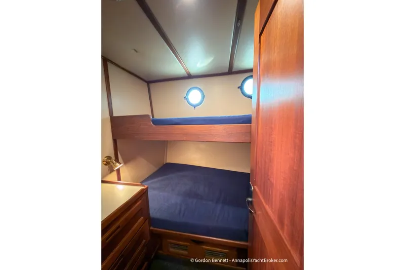 Dee Gee Yacht Photos Pics Cozy cabin interior of 1999 Nordic Tug 37 with bunk beds and wooden furnishings.