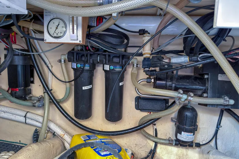 Dee Gee Yacht Photos Pics Engine room of a 1999 Nordic Tug 37 with various hoses and gauges.