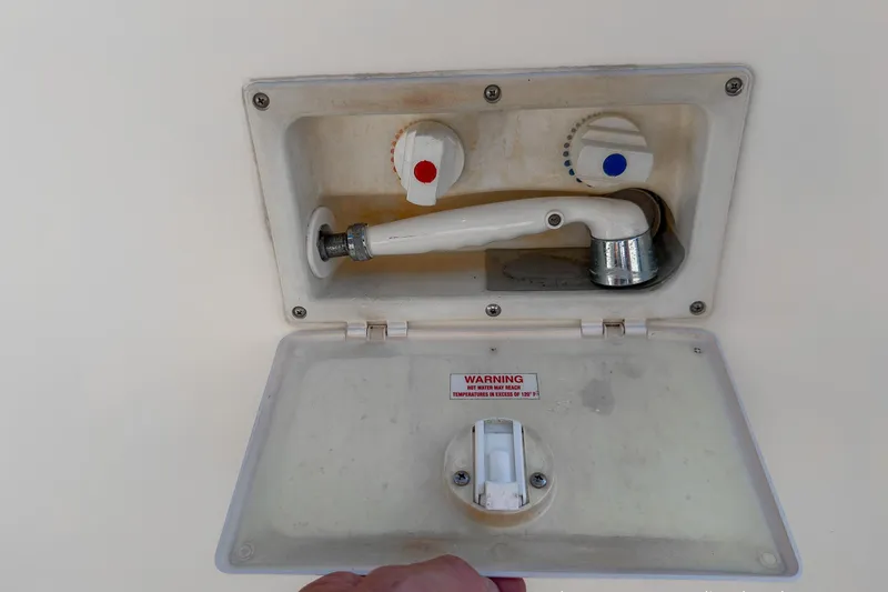 Dee Gee Yacht Photos Pics Outdoor shower compartment on a 1999 Nordic Tug 37 boat with hot and cold controls.