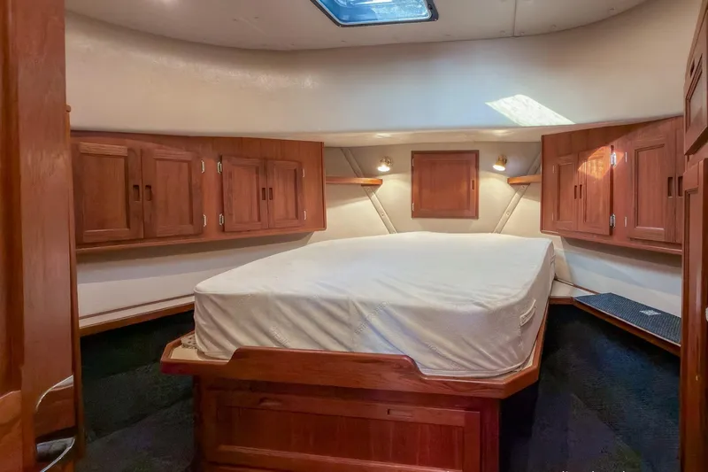 Dee Gee Yacht Photos Pics Cozy cabin interior of a 1999 Nordic Tug 37 with wood cabinetry and a skylight.