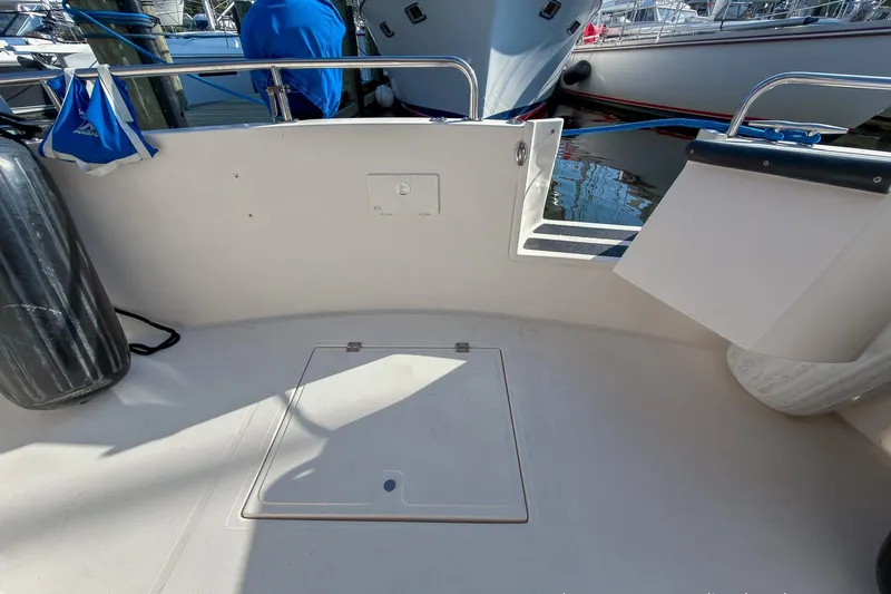 Dee Gee Yacht Photos Pics 1999 Nordic Tug 37 boat deck with storage hatch and railing.