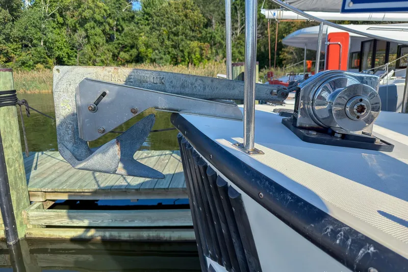 Dee Gee Yacht Photos Pics Anchor and winch on 1999 Nordic Tug 37 boat docked by wooden pier.
