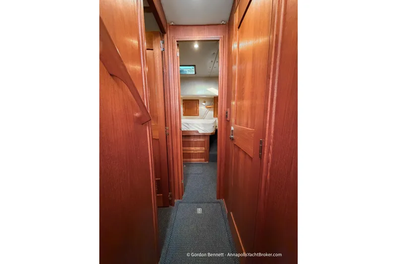 Dee Gee Yacht Photos Pics Interior hallway of 1999 Nordic Tug 37 with wooden paneling and visible cabin.