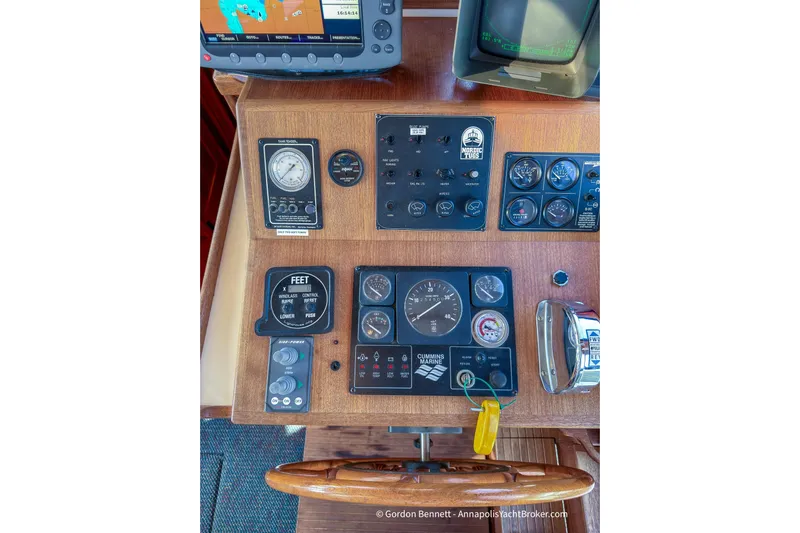 Dee Gee Yacht Photos Pics Control panel of a 1999 Nordic Tug 37 with various gauges and navigation equipment.