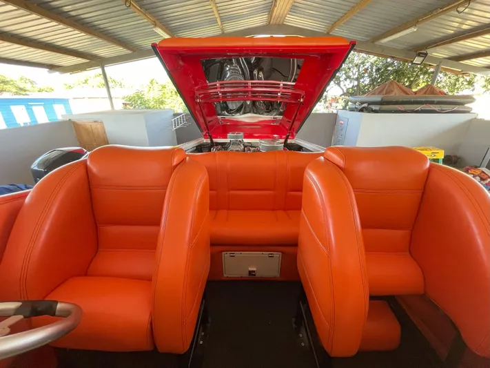 Driven Yacht Photos Pics 2002 Cigarette ROUGH RIDER boat interior with vibrant orange seating and open engine compartment.