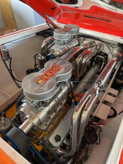 Driven Yacht Photos Pics Engine of a 2002 Cigarette ROUGH RIDER boat with chrome components and dual carburetors.