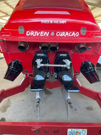 Driven Yacht Photos Pics Rear view of a 2002 Cigarette ROUGH RIDER boat, red with dual engines.
