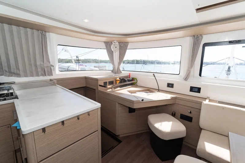  Yacht Photos Pics Interior of 2023 Lagoon 46 yacht with modern kitchen and panoramic windows.
