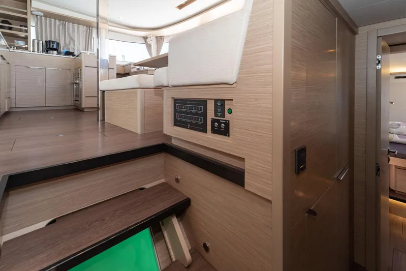  Yacht Photos Pics Interior of 2023 Lagoon 46 yacht, featuring modern wood finishes and control panel.