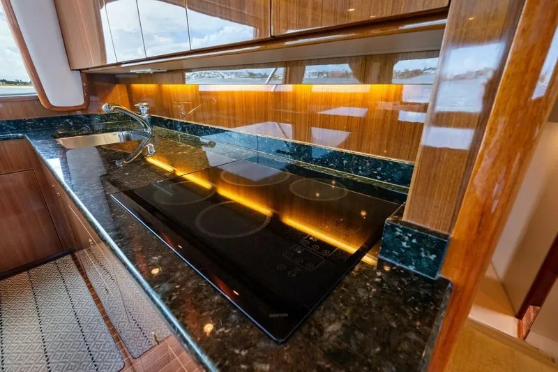 Summer Salt Yacht Photos Pics Luxurious kitchen interior of 2006 Viking 56 Convertible yacht with sleek countertops.