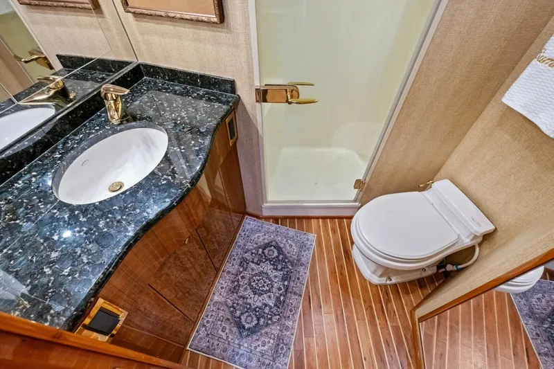 Summer Salt Yacht Photos Pics Luxurious bathroom in 2006 Viking 56 Convertible yacht with marble countertop and wooden flooring.