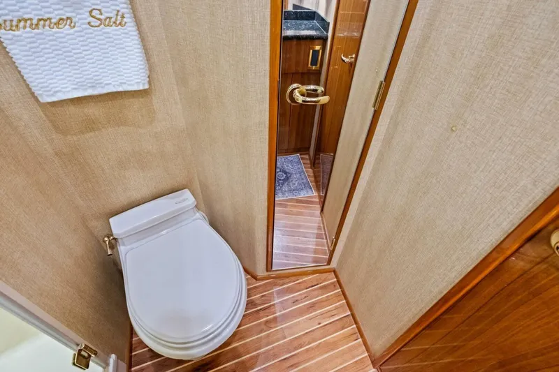 Summer Salt Yacht Photos Pics Bathroom interior of 2006 Viking 56 Convertible yacht with wooden flooring.