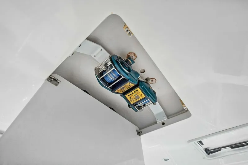 Summer Salt Yacht Photos Pics 2006 Viking 56 Convertible boat winch mechanism in ceiling compartment.