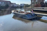 2022 GS 27 boat docked in a serene residential canal setting.