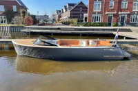 Modern GS 27 boat, 2022 model, docked in a residential canal setting.