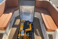 2022 GS 27 boat engine compartment with tan seating and wooden deck.