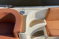 Luxury seating on 2022 GS 27 boat with cup holder and brown cushions.