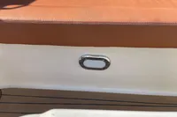 Brown cushioned seat on GS 27 boat, 2022 model, with white and chrome detailing.