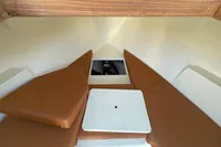 Interior of 2022 GS 27 boat with brown cushions and white table.