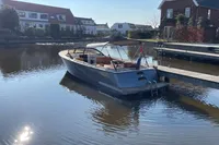 2022 GS 27 boat docked on a calm residential canal.